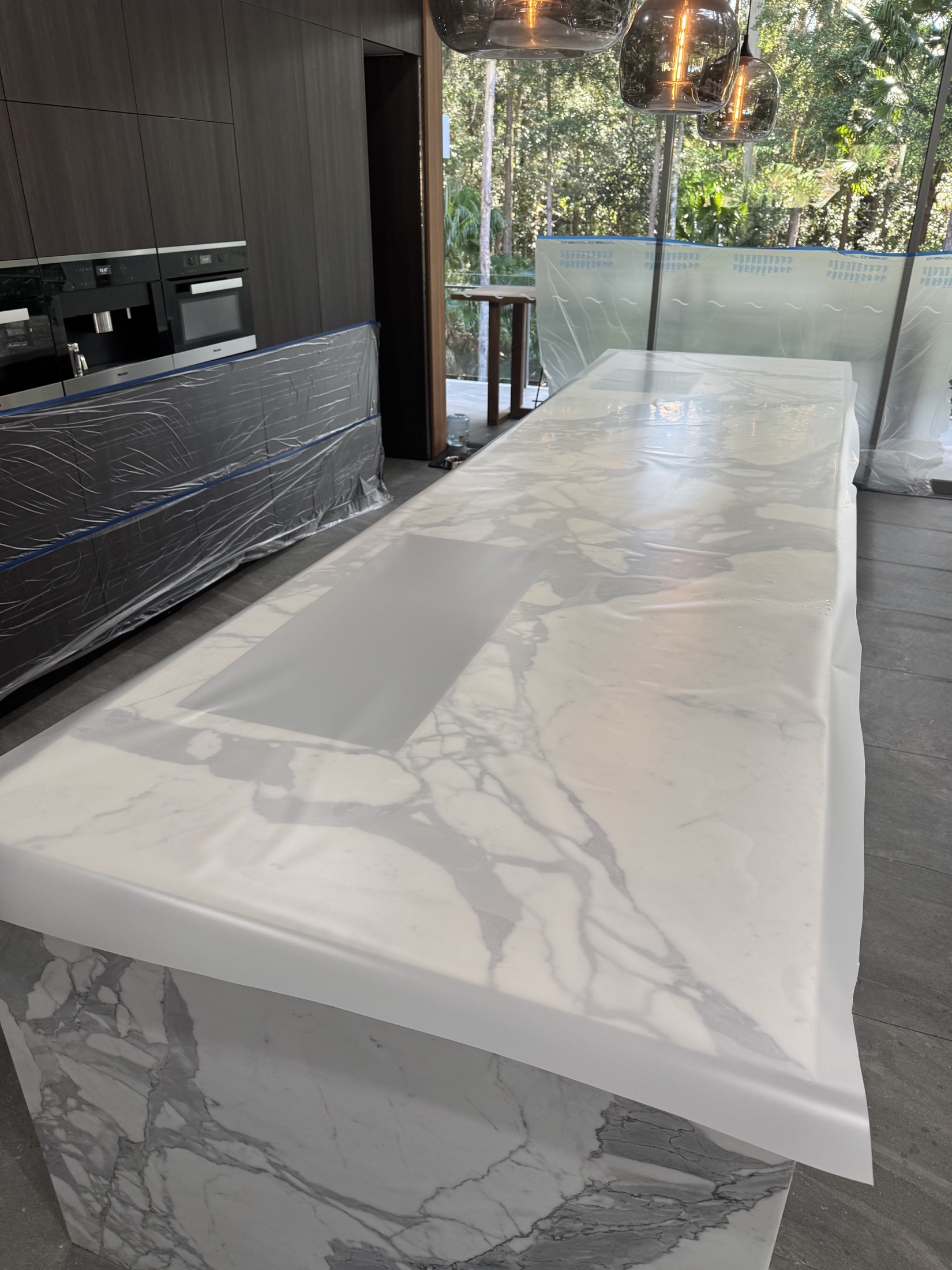 Protective film applied across a marble kitchen island
