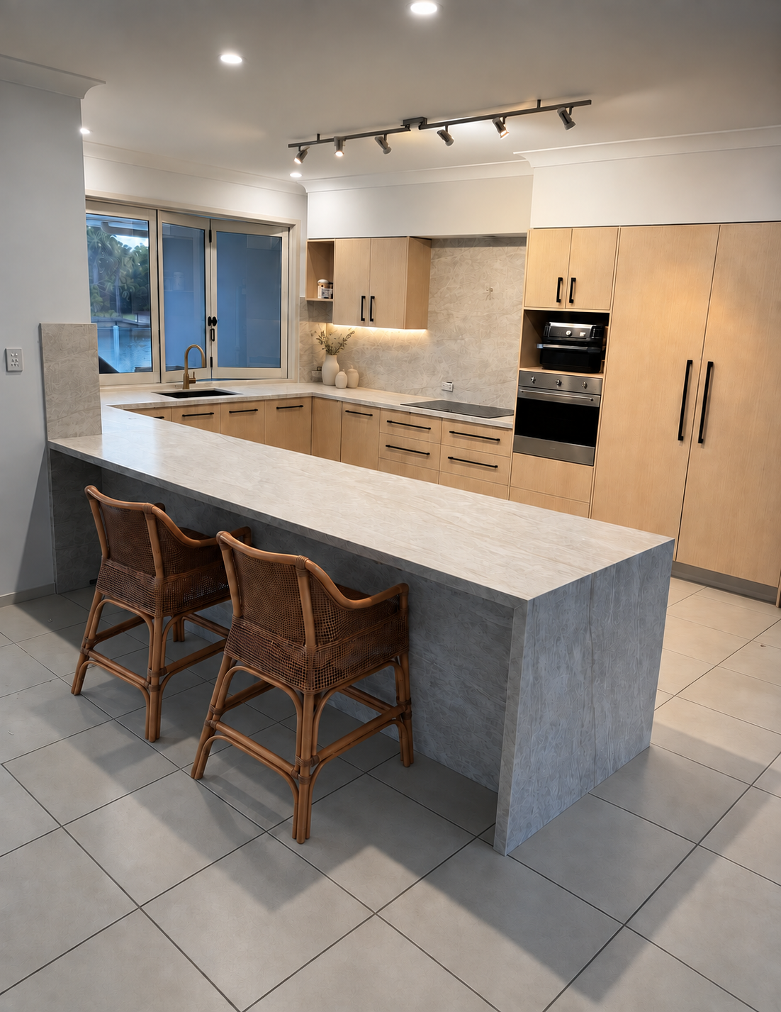 Mineral engineered stone kitchen island with chairs and a 40 millimetre profile